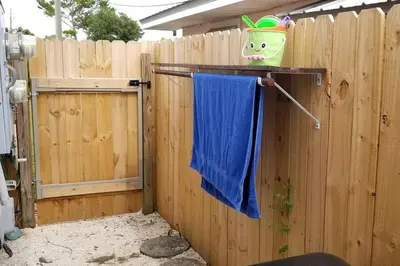 a blue towel hanging on a wooden fence at McDrifty's Hideaway in Panama City Beach