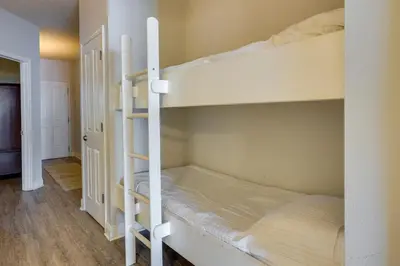 a couple of bunk beds in a room at Balcony and Beach Access Oceanfront PCB Condo in Panama City Beach