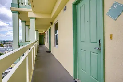 a corridor of a building with a green door at Balcony and Beach Access Oceanfront PCB Condo in Panama City Beach