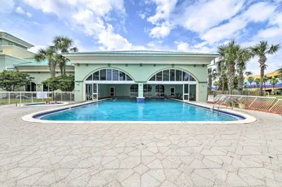 a large swimming pool in front of a building at Balcony and Beach Access Oceanfront PCB Condo in Panama City Beach
