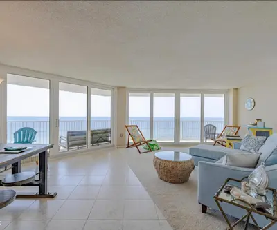 a living room with a view of the ocean at Dunes of Panama Resort in Panama City Beach
