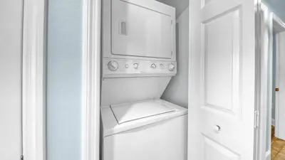 a white washer and dryer in a white room at Beachfront Condo #1413 Majestic Beach Resort in Panama City Beach