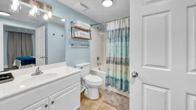 a bathroom with a sink and a toilet at Beachfront Condo #1413 Majestic Beach Resort in Panama City Beach