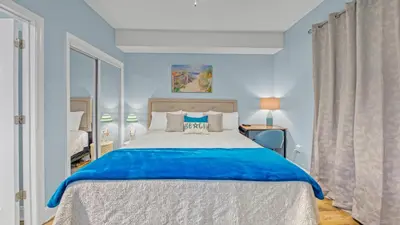 a bedroom with a large bed with blue walls at Beachfront Condo #1413 Majestic Beach Resort in Panama City Beach