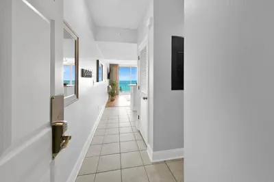 a hallway with white walls and a hallway with the ocean at Beachfront Condo #608 at Majestic Beach Resort in Panama City Beach