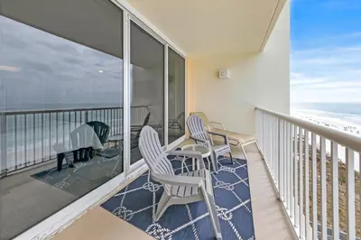 a balcony with two chairs and a piano and the ocean at Beachfront Condo #712 at Majestic Beach Resort in Panama City Beach