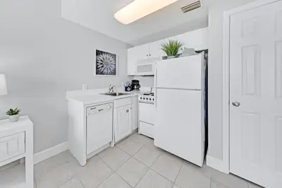 a white kitchen with white appliances and a white refrigerator at Beachfront Condo #712 at Majestic Beach Resort in Panama City Beach