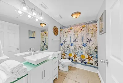 a bathroom with a sink and a toilet and a shower curtain at Beachfront Condo #712 at Majestic Beach Resort in Panama City Beach