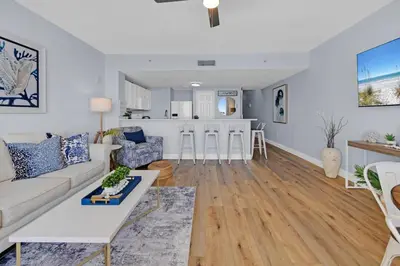 a living room with a couch and a table at Beachfront Condo #906 at Majestic in Panama City Beach