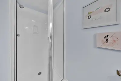 a shower with a glass door in a bathroom at Beachfront Condo #906 at Majestic in Panama City Beach