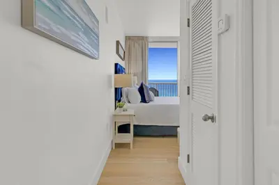 a bedroom with a bed and a view of the ocean at Beachfront Studio #1112 at Majestic in Panama City Beach