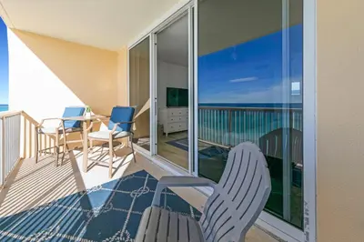 a balcony with chairs and a table on a balcony at Beachfront Studio #1112 at Majestic in Panama City Beach