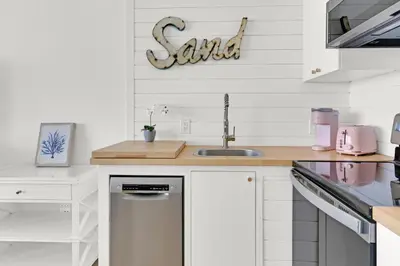 a kitchen with a sink and a dishwasher at Beachfront Studio #1112 at Majestic in Panama City Beach