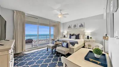 a bedroom with a bed and a view of the ocean at Beachfront Studio #212 at Majestic in Panama City Beach