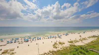 an aerial view of a beach with umbrellas and the ocean at Beachfront Studio #212 at Majestic in Panama City Beach