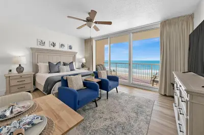 a bedroom with a bed and a view of the ocean at Beachfront Studio #509 at Majestic in Panama City Beach