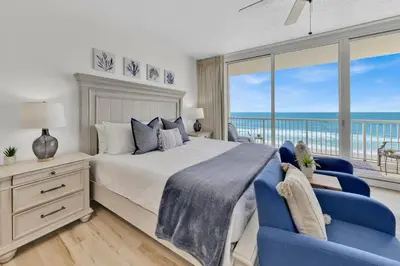 a bedroom with a bed and a view of the ocean at Beachfront Studio #509 at Majestic in Panama City Beach
