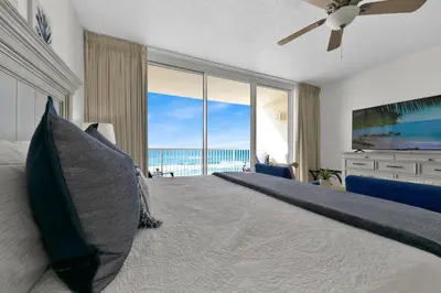 a bedroom with a bed with a view of the ocean at Beachfront Studio #509 at Majestic in Panama City Beach