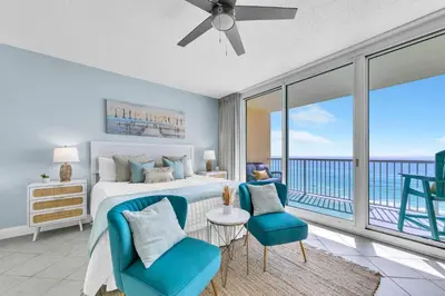 a bedroom with a bed and a view of the ocean at Beachfront Studio #709 at Majestic in Panama City Beach