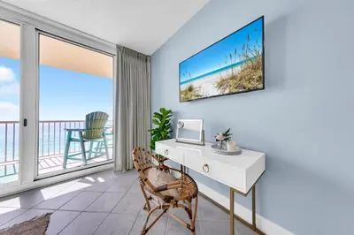 a living room with a desk and a view of the ocean at Beachfront Studio #709 at Majestic in Panama City Beach