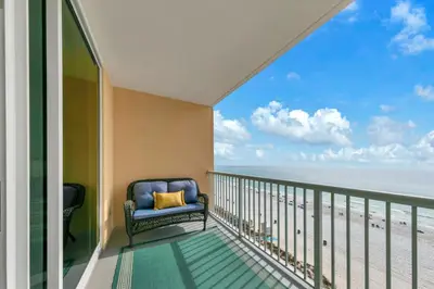 a balcony with a chair and a view of the beach at Beachfront Studio #709 at Majestic in Panama City Beach