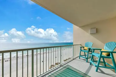 a balcony with two chairs and a view of the beach at Beachfront Studio #709 at Majestic in Panama City Beach