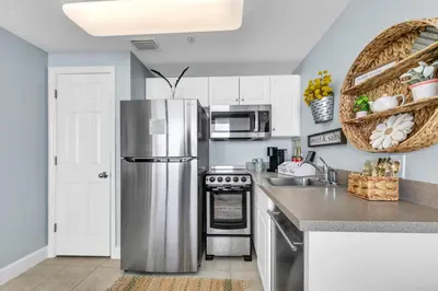 a kitchen with a stainless steel refrigerator at Beachfront Studio #709 at Majestic in Panama City Beach