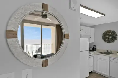 a kitchen with a round mirror on the wall at Beachfront Studio #809 at Majestic in Panama City Beach