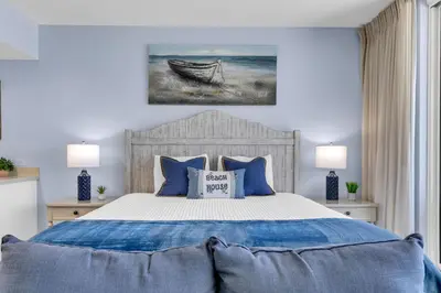 a bedroom with a bed with a boat on it at Beachfront Studio #909 at Majestic in Panama City Beach