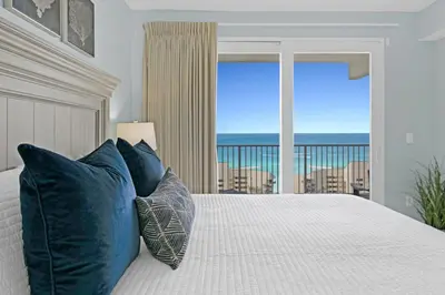 a bedroom with a bed with a view of the ocean at Gulfview Condo #1809 at Laketown Wharf in Panama City Beach