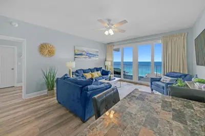 a living room with blue furniture and a view of the ocean at Gulfview Condo #1809 at Laketown Wharf in Panama City Beach