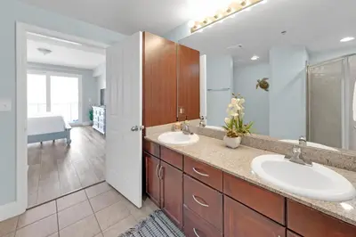 a bathroom with two sinks and a large mirror at Gulfview Condo #1809 at Laketown Wharf in Panama City Beach