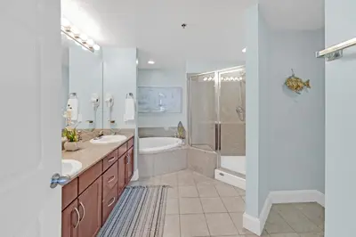 a bathroom with two sinks and a tub and a shower at Gulfview Condo #1809 at Laketown Wharf in Panama City Beach