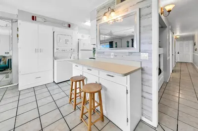 a kitchen with a counter and two stools at Oceanfront Condo #1320 at Summit in Panama City Beach