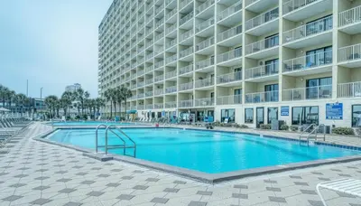 a swimming pool in front of a large building at Oceanfront Condo #1320 at Summit in Panama City Beach
