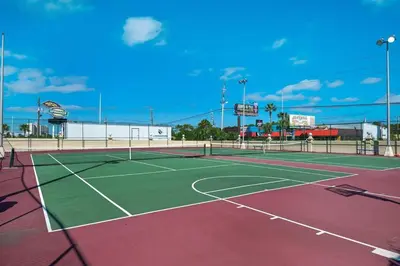 a tennis court with a tennis net on it at Oceanfront Condo #1320 at Summit in Panama City Beach