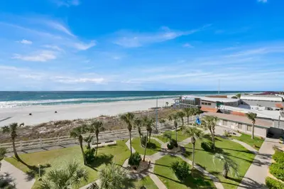 a view of the beach from the balcony of a resort at Oceanfront Condo #507 at Summit Beach Resort in Panama City Beach