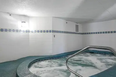 a swimming pool with a hot tub in a room at Oceanfront Condo #629 at Summit Beach Resort in Panama City Beach