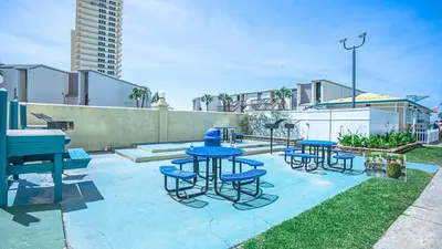 a group of blue tables and chairs on a patio at Oceanfront Condo #629 at Summit Beach Resort in Panama City Beach