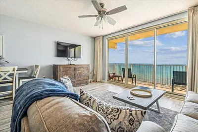 a living room with a couch and a view of the ocean at Shores of Panama # 1902 condo in Panama City Beach