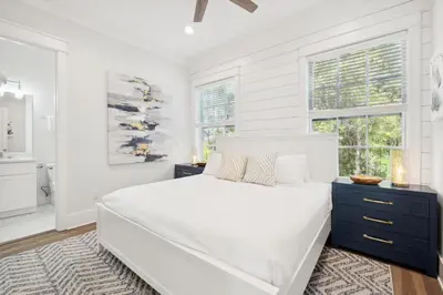 a white bedroom with a large bed and windows at 30A Beach House - Cozinest at Treetops by Panhandle Getaways in Rosemary Beach