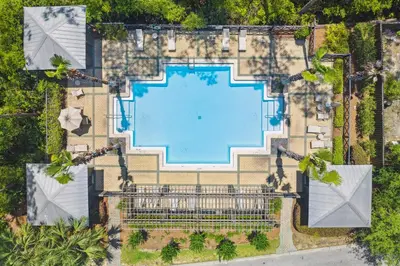 an overhead view of a swimming pool in a resort at 30A Beach House - Cozinest at Treetops by Panhandle Getaways in Rosemary Beach