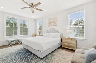 a white bedroom with a bed and a couch at 30A Beach House - Cozinest at Treetops by Panhandle Getaways in Rosemary Beach