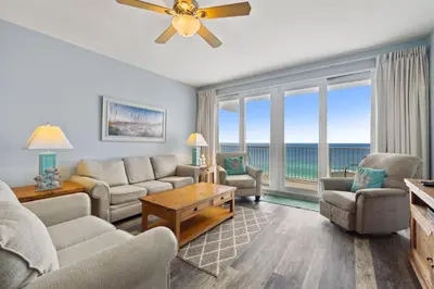 a living room with a view of the ocean at Laketown Wharf #1807 by Nautical Properties in Panama City Beach