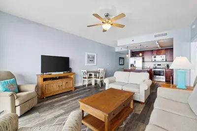 a living room with a couch and a table at Laketown Wharf #1807 by Nautical Properties in Panama City Beach