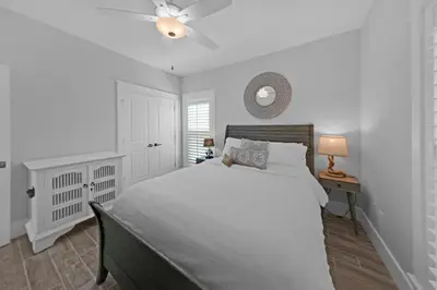 a white bedroom with a large bed and a window at Sea Suite - Large hot tub with an easy walk to the beach in Santa Rosa Beach