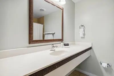 a bathroom with a sink and a mirror at Origin at Seahaven #1703 by Nautical Properties in Panama City Beach