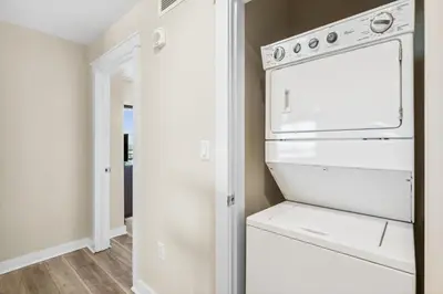 a kitchen with a white stove and an open refrigerator at Origin at Seahaven #1703 by Nautical Properties in Panama City Beach