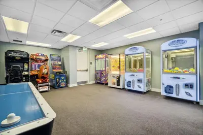 a room with arcade games and a pool table at Origin at Seahaven #1703 by Nautical Properties in Panama City Beach