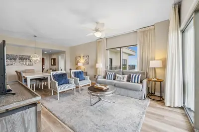 a living room with a couch and a table at Origin at Seahaven #1703 by Nautical Properties in Panama City Beach